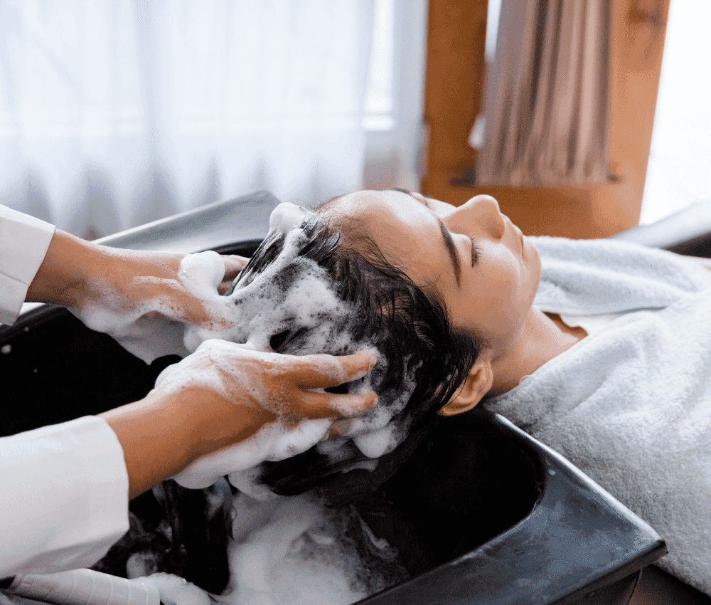 Woman getting her hair washed at a salon.